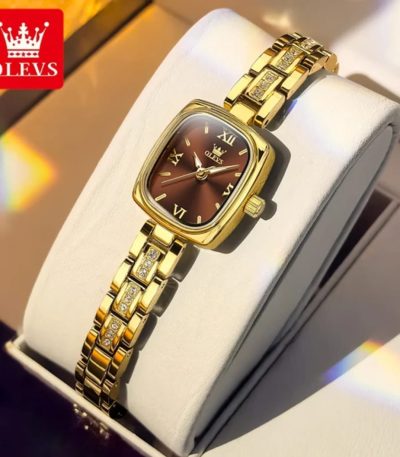 A close-up of the OLEVS 3695 women's quartz watch showing its gold-colored case, brown dial, and stone-accented bracelet.