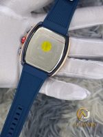 The back of the CURREN 8442 watch, held by a gloved hand, showing the stainless steel case and blue silicone band.