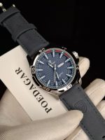 A gloved hand holding the POEDAGAR 895 men's watch, which has a blue textured dial and a matching blue leather strap.