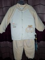 A baby cartoon velvet thermal base layer set in cream and white, with an applique of a bear in a car on the button-up top.
