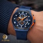A close-up of the Naviforce 8051T Blue Silicone Chronograph Watch on a man's wrist, showing its blue and orange details.