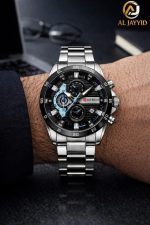 A man wearing the Curren 8402 watch, featuring a silver metal band and a black chronograph dial with light blue accents.