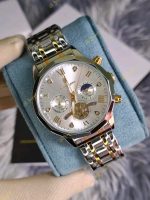 A gloved hand holding a Poedagar 938 men's luxury watch with a white dial and a two-tone stainless steel bracelet.