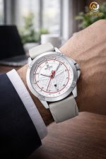 A man's wrist wearing the NAVIFORCE 8031 Men's Gray Quartz Watch with a white dial and gray strap in an office setting.