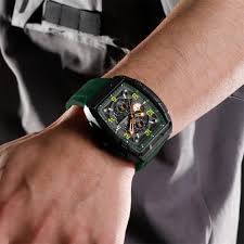 A man wearing the Naviforce 8052T Green Silicone Chronograph Watch on his wrist, showing its black case and green band.