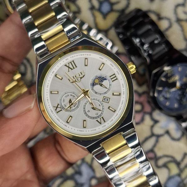 A close-up, top-down shot of a gold-toned LIGE luxury chronograph watch being held by a hand