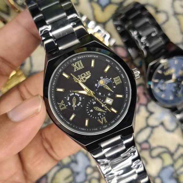 A close-up, top-down shot of a gold-toned LIGE luxury chronograph watch being held by a hand