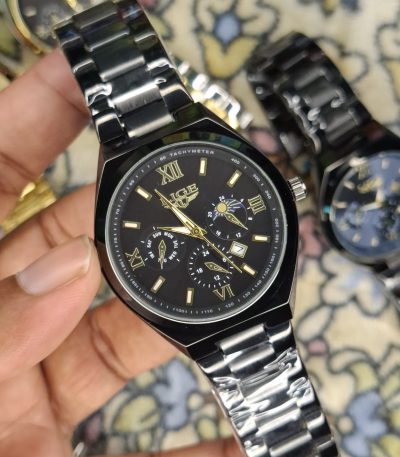 A close-up, top-down shot of a gold-toned LIGE luxury chronograph watch being held by a hand