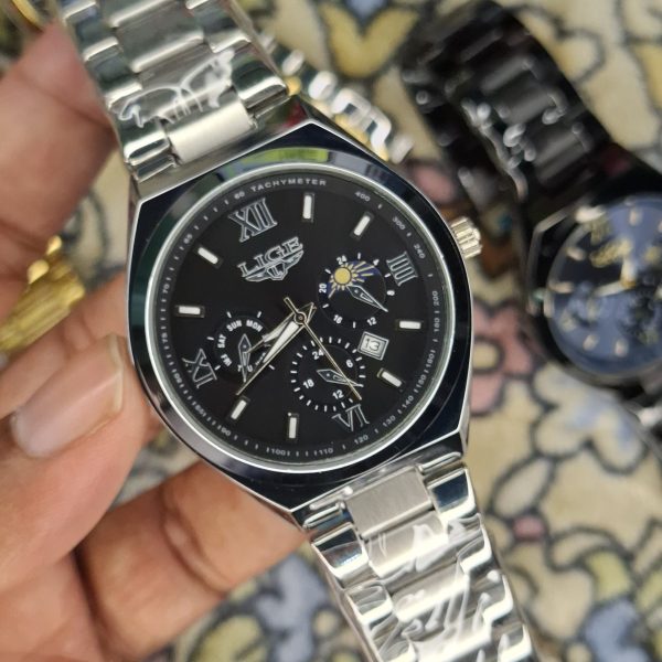 A close-up, top-down shot of a gold-toned LIGE luxury chronograph watch being held by a hand