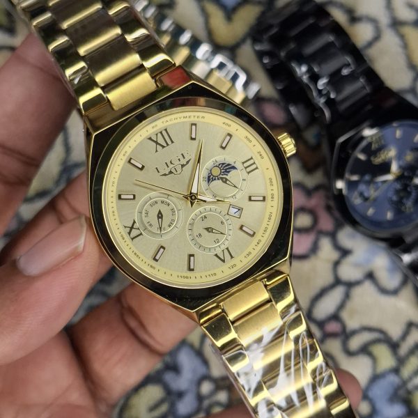 A close-up, top-down shot of a gold-toned LIGE luxury chronograph watch being held by a hand