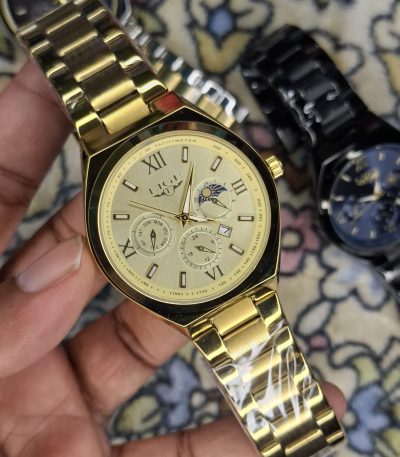A close-up, top-down shot of a gold-toned LIGE luxury chronograph watch being held by a hand