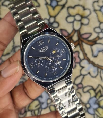 A close-up, top-down shot of a gold-toned LIGE luxury chronograph watch being held by a hand